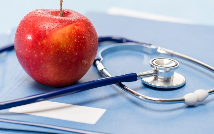 healthcare stethoscope and red apple
